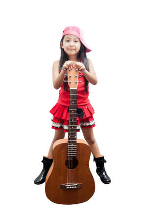 Confident little girl standing with her guitar.の写真素材