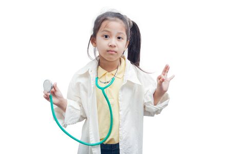 Little asian girl in a doctors uniform on a white background.の写真素材