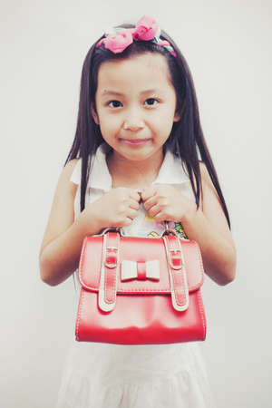 Little girl in white dress as fashion model over white background.の写真素材