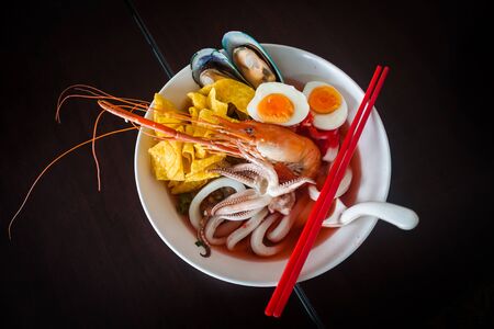 Noodles with seafood soup and red sauce, yong tau foo.の写真素材
