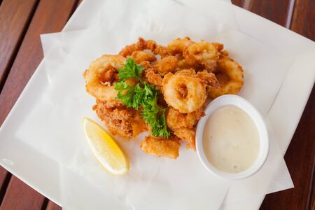 fried squid rings breaded with lemonの写真素材