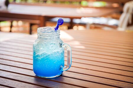 Blue Hawaiian cocktail on the wood table.の写真素材
