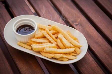 French fries hot with ketchup on plate.の写真素材