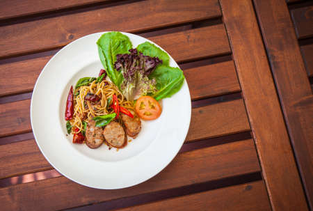 Stir-Fried Spaghetti with Thai Spicy Sausage.の写真素材