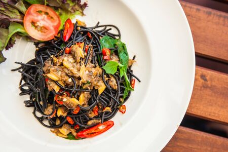Black spaghetti. Black seafood pasta with clams.の写真素材