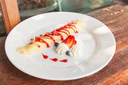 Sweet Rolled Pancakes roll with berry and cream.の写真素材