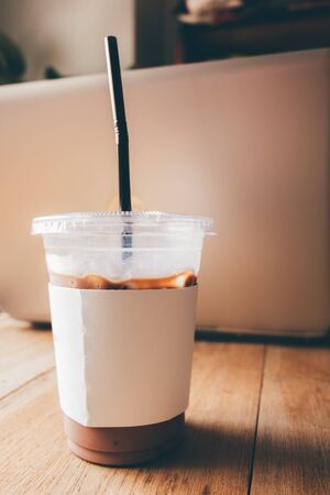 Iced cocoa drink on a wooden table at a cafe. Picture art style.の写真素材