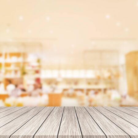 Wooden board empty and department store blurred background. 
Display montage products.の写真素材