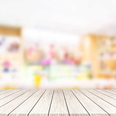 Wooden board empty and department store blurred background. 
Display montage products.の写真素材