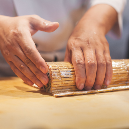Hands preparing japanese sushi.の写真素材