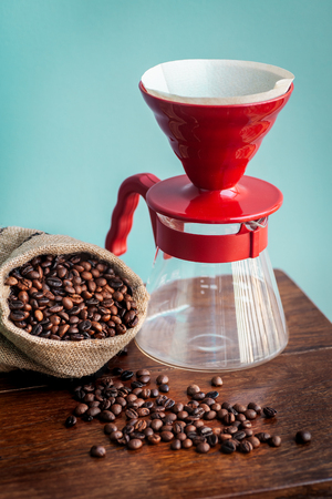 Roasted coffee bean in vintage grinder with coffee maker.の写真素材