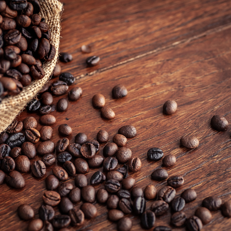 Roasted coffee beans in sacksの写真素材
