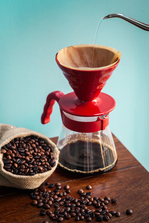 Make a drip brewing, pouring water over roasted, coffee beans contained in a filter.の写真素材