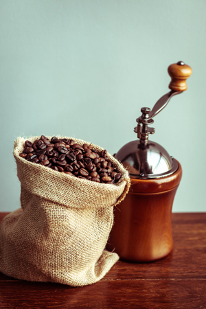 Roasted coffee bean in vintage grinder with coffee maker.の写真素材