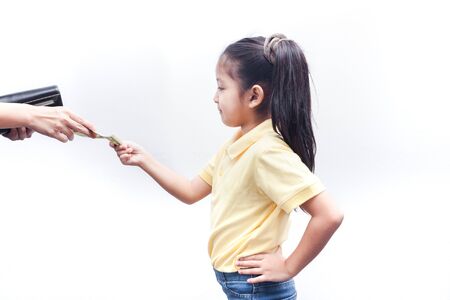 Parent pulls out money from wallet to little girl, on white background.の写真素材