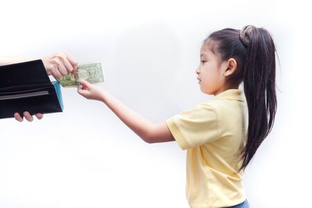 Parent pulls out money from wallet to little girl, on white background.