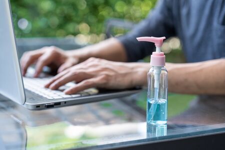 Work from home and alcohol sanitizer in pump bottle. health care conceptの写真素材