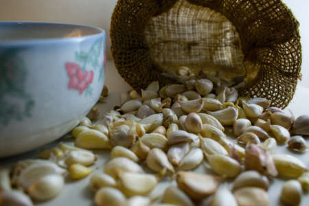 Garlic from sacks on a white background.の写真素材