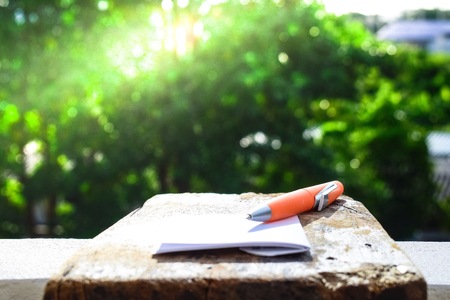 A notebook with white paper on a wooden floor for business notes.の写真素材