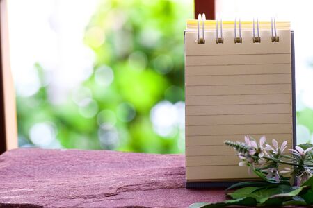 Paper for notes on wood and bokeh background using wallpapers or background.