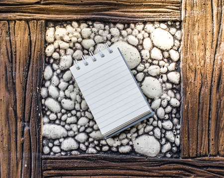 white paper for notes on the wood and stone background using wallpaper and background.の写真素材