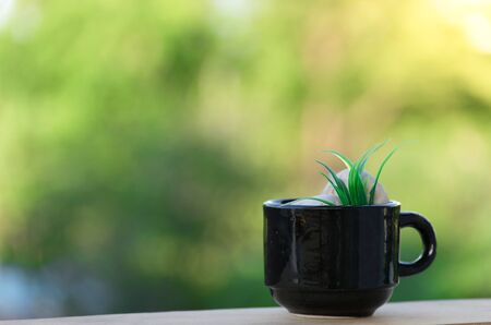 Coffee mug on wooden floor and bokeh backgroundの写真素材