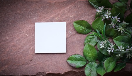 Artificial flowers  and paper on a bokeh backgroundの写真素材