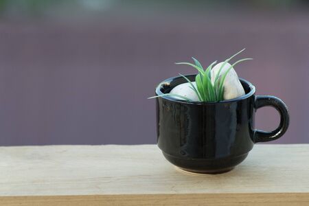 Coffee mug on wooden floor and bokeh backgroundの写真素材