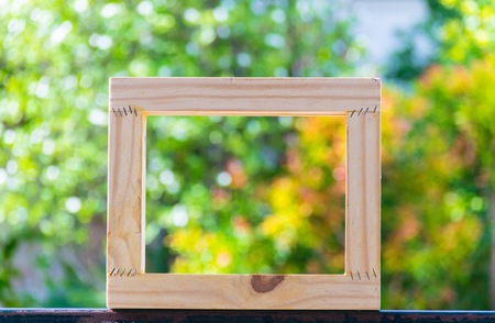 Picture frame on blurred tree bokeh background using wallpaper or background.の写真素材