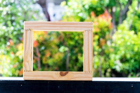 Picture frame on blurred tree backgroud using wallpaper or background.の写真素材