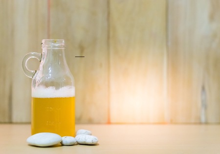 Beer bottle put on wood with wooden background using wallpaper for party at night.の写真素材