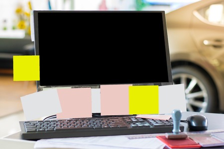 Computer on a wood desk with a notepad in the office. Using wallpaper or background for bussiness image.の写真素材