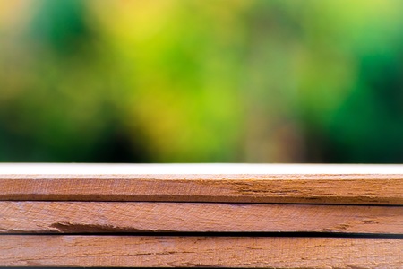 Empty wooden floor with tree blurred bokeh background. Using wallpaper or background for copy space image.の写真素材