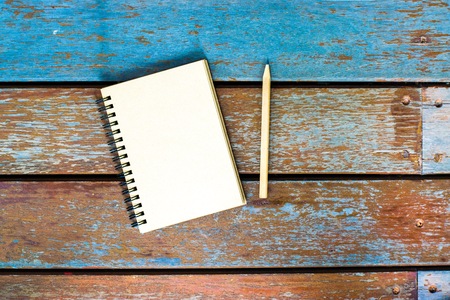 Notepad with pencil on wood board background. using wallpaper or background for education photo. Take note of the product for book with  paper.の写真素材