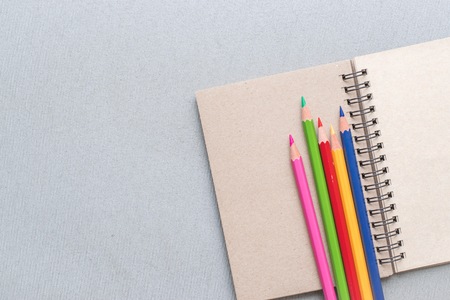Notepad with pencil  on wood board background. using wallpaper or background for education, business...