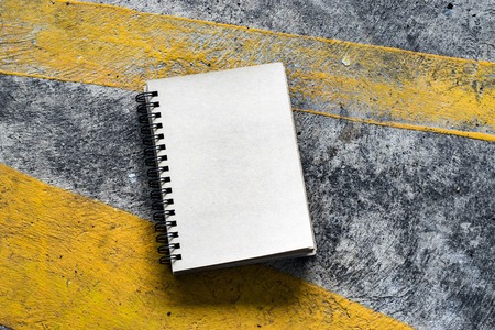 Notepad on street background. In nature and city. using wallpaper or for education photo. Dry notebook take note of the product for book with paper and concept or copy space.の写真素材