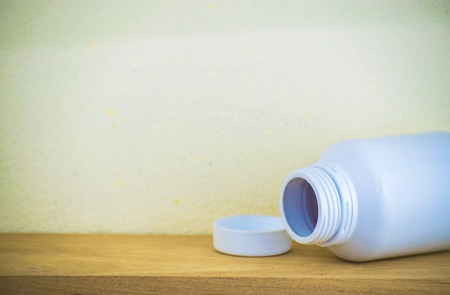 Bottle made to plastic on the wood with wall background. Using wallpaper for package or product and drug image.の写真素材