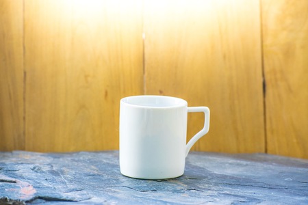 Glass white color  on a wood background.  Using wallpaper or background for  package with product and refreshing.の写真素材