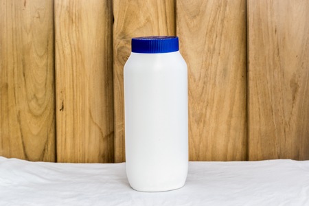 Bottle made to plastic on the wood background.Using wallpaper for package or product and drug image.の写真素材