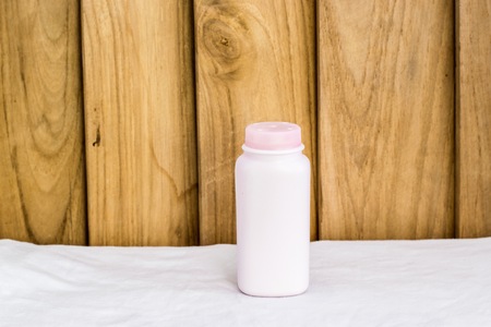 Bottle made to plastic on the wood background.Using wallpaper for package or product and drug image.の写真素材