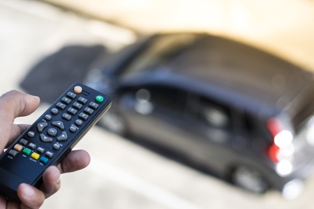 Remote control on car blurry background in city. Using control and driving concept or transportation with automotive, copy space.の写真素材