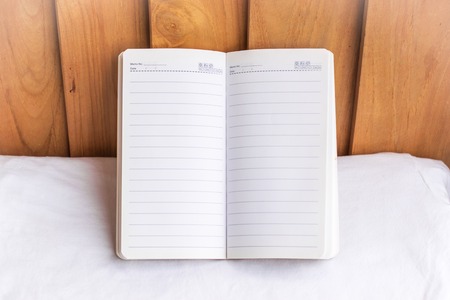 Notepad on wood background.using wallpaper for education, business photo. Take note of the product for book with paper concept or copy space and refreshing.の写真素材