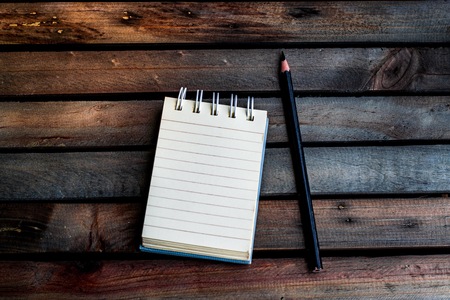 Notepad with pencil on wood background.using wallpaper for education, business photo. Take note of the product for book with paper concept or copy space and refreshing.の写真素材