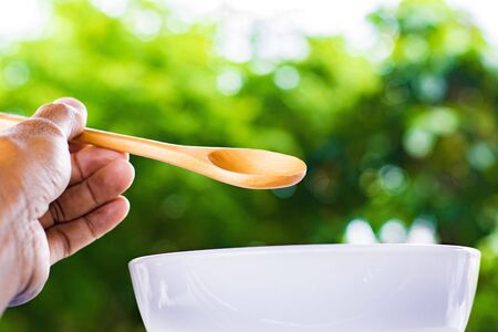 Wooden spoon on tree blurred background.Using food composition image.For food with candy and snacks image to package with products and delicious taste.の写真素材
