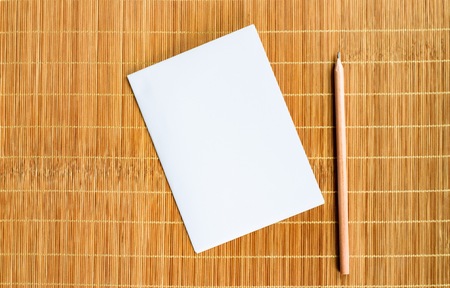 Notepad with pencil on wood board background. using wallpaper or background for education, business photo. Take note of the product for book with paper and concept or copy space.の写真素材