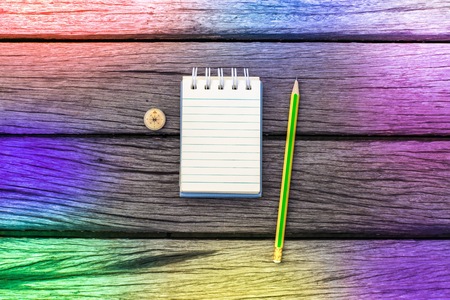 Notepad with pencil on wood board background. using wallpaper or background for education, business photo. Take note of the product for book with paper and concept or copy space and note.の写真素材