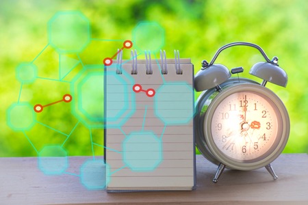 Notepad with clock and robot graph vector on wood board background.