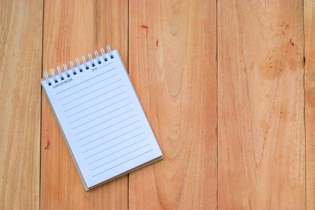 Notepad with wood board background.using wallpaper or for education, business photo.Take note of the...