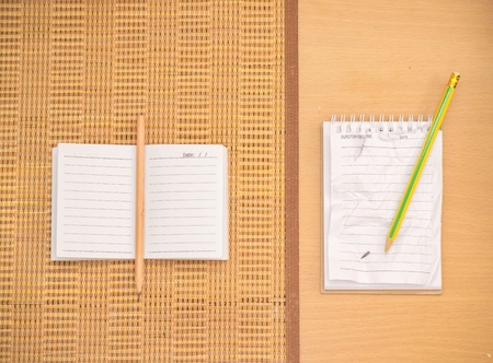 Notepad with pencil on wood board background.using wallpaper for education, business photo.Take note of the product for book with paper and concept or copy space.の写真素材