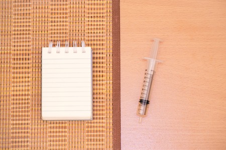 Notepad with pencil on wood board background.using wallpaper for education, business photo.Take note of the product for book with paper and concept or copy space.の写真素材